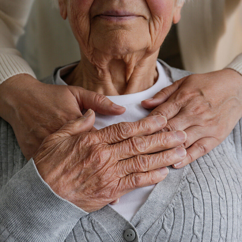 loved-one-clasping-caretakers-hands